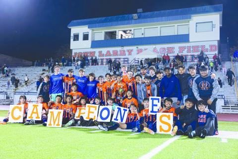 Habersham Central boys soccer players celebrate their region title with fellow students and friends Tuesday night after knocking off North Forsyth 1-0 to clinch first place. LANG STOREY/Staff