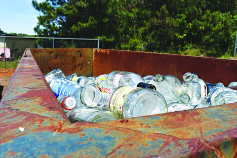 Glass bottles sit at the Cornelia Recycling Center waiting to be hauled and processed. JULIANNE AKERS/Staff