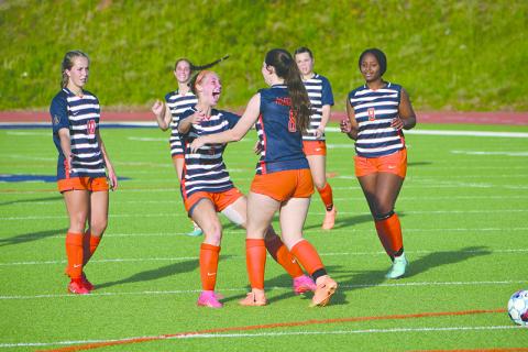 Habersham Central’s Piper Turner (left) and Emylie Nichols celebrate a goal during the Lady Raiders’ dominant first-round playoff win. LANG STOREY/Staff