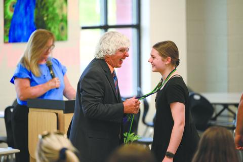Coach Morris Brooks smiles as he puts the Work-Based Learning cord on  Habersham Central senior Kaitlyn  Gibson at Thursday’s annual banquet. ZACH TAYLOR/Special 
