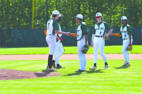 Tallulah Falls’ Gregory Mendez, Andrew Skvarka and Diego Gonzalez hype up pitcher Chase Pollock before the start of an inning against Oglethorpe in the first round of the playoffs. LANG STOREY/Staff