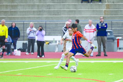 Raiders senior Juan Lara boots the soccer ball down the pitch in hopes of a scoring opportunity against Sprayberry. ZACH TAYLOR/Special