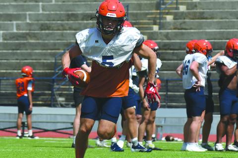 Zeke Whttington turns upfield after securing a pass at practice Wednesday.