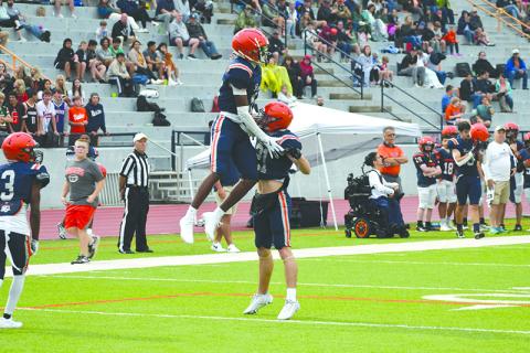 Habersham’s Jay Feltus gets some air while celebrating with Landyn Savage. LANG STOREY/Staff