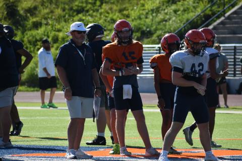 Coach Benji Harrison and quarterback DJ Pass look on as the second team lines up during padded camp. LANG STOREY/Staff