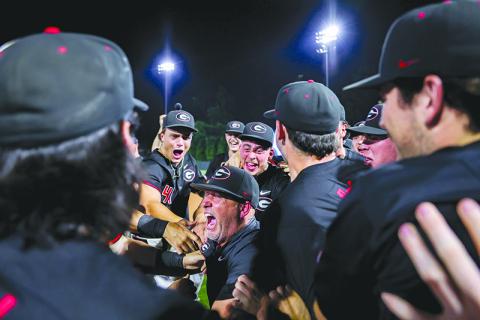 Georgia Head Coach Wes Johnson celebrates with his team after the Bulldogs advanced to the NCAA Super Regionals Sunday night. KARI HODGES/UGAAA