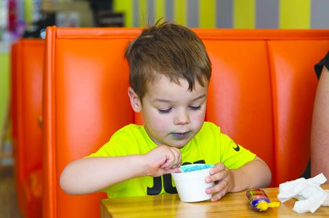 Tommy Howard enjoys his Cookie Monster ice cream at Scoops in Clarkesville. ZACH TAYLOR/Special