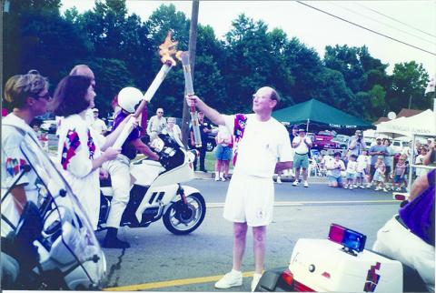 Dr. Martha Cantrell passes the Olympic flame to Community Bank & Trust President Charlie Miller in 1996. Below, Cantrell got to keep her torch to mark the historic moment. SUBMITTED 