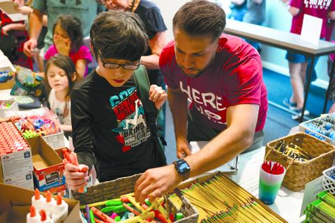 Niko Andrade (right) helps Daniel Arriaga pick the best color highlighters for his upcoming school year at last year’s Back to School Bash in Baldwin. ZACH TAYLOR/Special