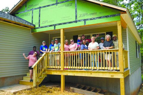 Volunteers celebrate the completion of a recent Habitat for Humanity build in Demorest. SUBMITTED