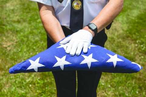 DAV Commander and Honor Guard member Jim Morgan presents the flag wearing white gloves. ZACH TAYLOR/Special 