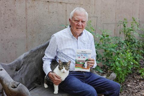 Deal sits with real-life Veto and a copy of his new book. COURTESY OF ANDREA HUDSON
