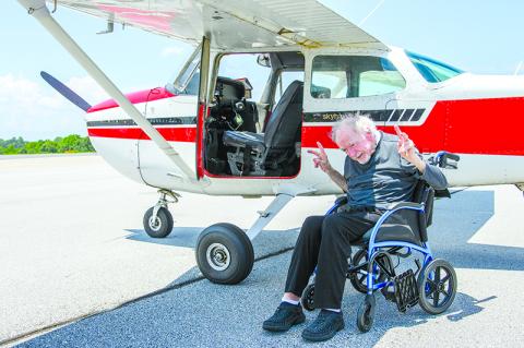 Bill McNamara gives two peace signs after his 81st birthday flight with Erich Fritchman of Horizon Dreams. ZACH TAYLOR/Staff