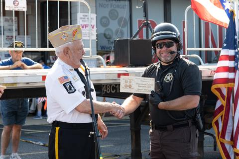 VFW Post 7720 Commander Barry Church hands Aaron Autry a Heroes of Service Award during the opening ceremony of Heroes Fest on Saturday.  ZACH TAYLOR/Staff 