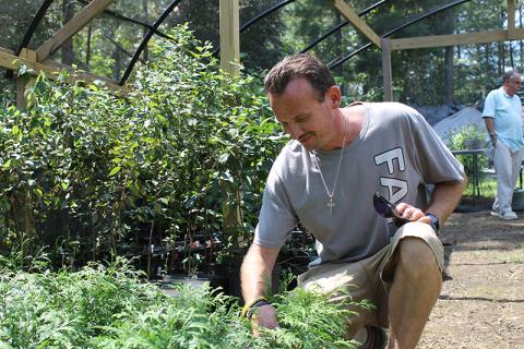 Jonathan Twitty tends to saplings at Victory Home. BRIAN WELLMEIER/Staff