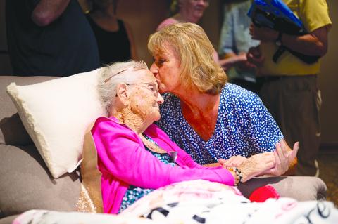 Shown here, Rhonda Vinson kisses Chastain on the forehead when visiting during the party hosted at Habersham EMC on Sunday. ZACH TAYLOR/Special