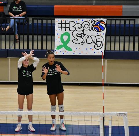 Habersham’s Maci Williams (left) and McKenzie King warmup in shirts honoring the cause last Thursday night in Mt. Airy. LANG STOREY/Staff