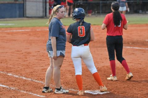 Emily Diffenderfer talks strategy with Assistant Coach Ansley Patrum after getting on base last week. TOM ASKEW/Special