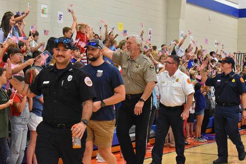 Local first responders wave to students at Fairview. From left, Kenneth Puzio and Will Sexton with White County EMS, Habersham County Sheriff Joey Terrell, Cornelia Fire Marshal Josh Hazle and Cornelia Firefighter Chris Bruce. JULIANNE AKERS/Staff 