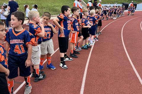 Above, Players from the Habersham rec department NGYFA teams lined the track and formed a tunnel at the last Habersham Central home game. LANG STOREY/Staff