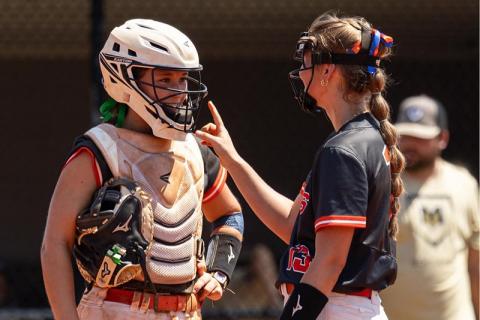 Catcher Shelby Rinefierd chats with Kaylan Barrett during a game earlier this season. MEG LABARBERA/HCHS
