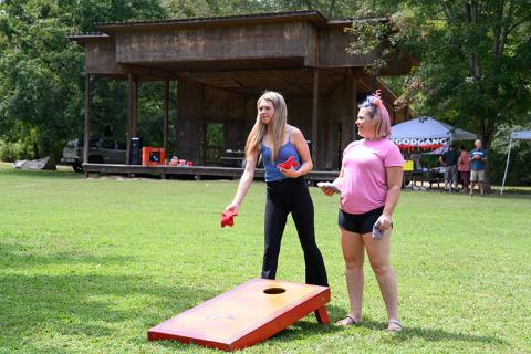 Bailey Ward and Tiffany Young play a game of cornhole at the Recovery Festival on Saturday. ZACH TAYLOR/Staff