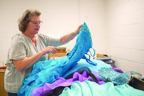 Habersham County Family Connection Executive Director Donna Barrett sorts through donated dresses. JULIANNE AKERS/Staff