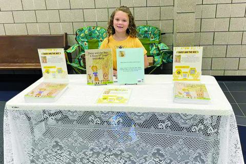 Reese Ledford tables at the Habersham County Chamber of Commerce Junior Business fair in April. SUBMITTED