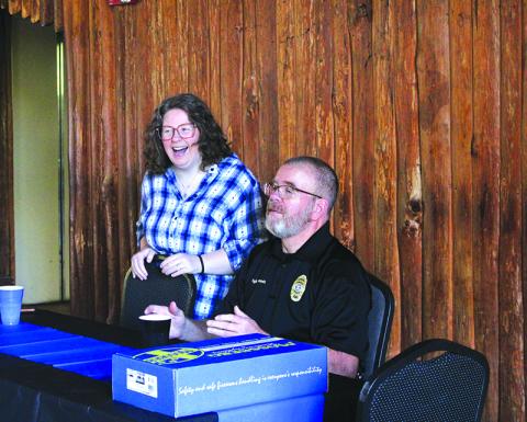Krystal Risher (left) and Sgt. Deloney Gunnels (right) laugh with a friend during the celebration of Gunnels’ retirement. Risher, who is Gunnels’ daughter, said she is very proud of her father’s accomplishments. HANNAH CAUDELL/Staff