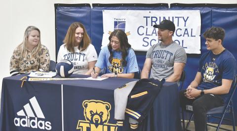 Surrounded by her family and TCS’ Celina Chitwood, Madison Ward put ink to paper Friday, making her commitment to Truett McConnell official. LANG STOREY/Staff
