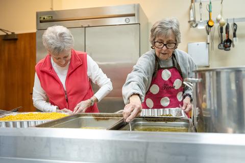 Claudia Jessup and Tina Evans work to get the most out of the corn and green bean batches. ZACH TAYLOR/Staff