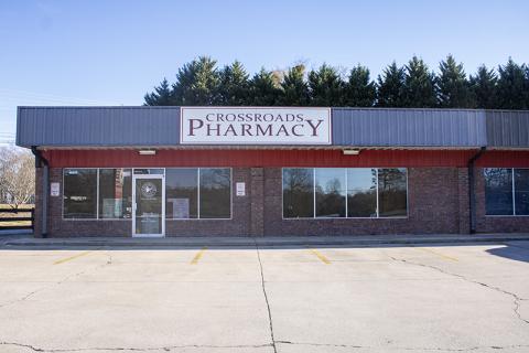 Crossroads Pharmacy sits vacant in its lot in Demorest. In the window, a sign sits that redirects customers to Walgreens for their prescriptions. HANNAH CAUDELL/Staff