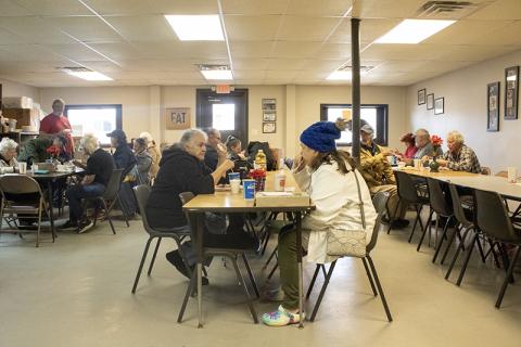 From left, Jennie Tomlin sits and chats across the table from Diane Higgins, who enjoys a warm cup of chili on a cold December day. HANNAH CAUDELL/Staff