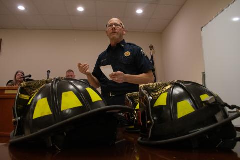 Baldwin Fire Chief Joe Roy stands before the audience at the Baldwin City Council meeting on Monday night to talk about Baldwin’s first department graduating class. New firefighter helmets sat on the table before him. Helmets are traditionally given to new firefighters upon graduation. HANNAH CAUDELL/Staff
