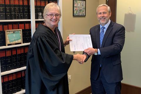 Probate Judge Pamela Wooley, left, shakes hands with Superior Court Judge Chan Caudell in a swearing-in ceremony in December. HABERSHAM COUNTY/Submitted