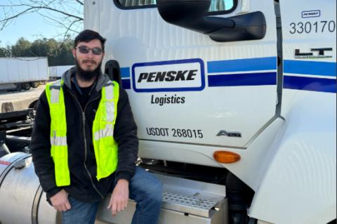 Penske Logistics Truck Driver William Mitchell of Alto is pictured with the Penske truck he drives. Mitchell was responsible for saving the life of a pickup truck driver after witnessing a crash between the pickup truck and a fuel tanker. SUBMITTED