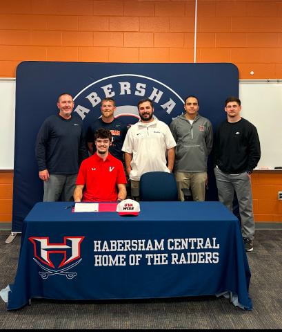 HCHS senior Everett Rudeseal officially put pen to paper last week. Much of the Habersham Football staff - including (from left) Coach Benji Harrison, JR Roberson, Drew Ferguson, Isaiah Murphy and Garrett Kinsey - were in attendance to witness. SUBMITTED