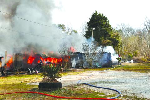 Firefighters work to extinguish a double wide home engulfed in flames on Ga. 115 in the Fairview community west of Clarkesville. Submitted