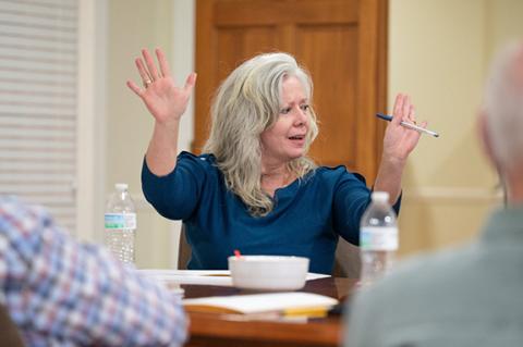 Councilwoman Angelia Kiker raises her hands in joy after a unanimous vote to purchase the old courthouse property for $1.19 million. Kiker was the main driving force behind the city's historic purchase. (Zach Taylor/Staff)