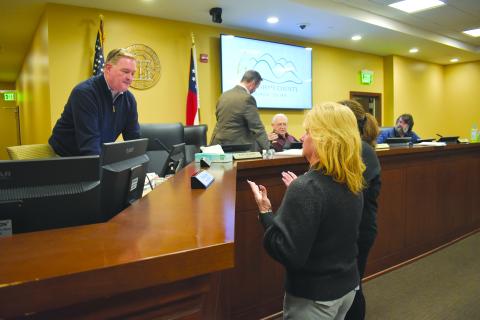 As the board exits the room for executive session, Interim County Manager Tim Sims assures Reign Elite Owner Neva Daniels that safety is the county’s top concern in repairs to the gymnastics facility. Samantha Sinclair/Staff