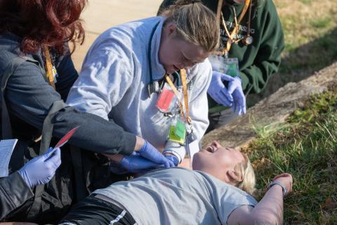 Piedmont nursing student Gracie Martin puts pressure on a gunshot wound during the disaster drill. Nursing students got a firsthand look at what a chaotic scene in the real world could look like. ZACH TAYLOR/Staff