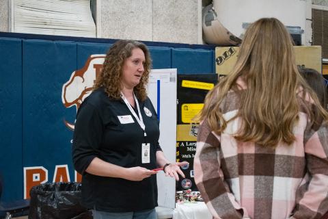 E-911 Dispatcher Kailey Gould starts a conversation with students interested in her line of work.  HANNAH CAUDELL/Staff