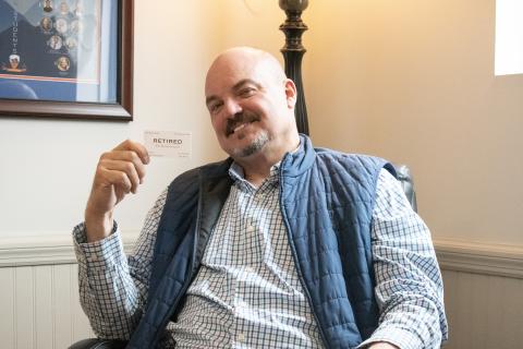 HANNAH CAUDELL/Staff Superintendent Matthew Cooper holds up a new kind of business card, one that suggests he won’t be available anytime soon after Thursday. Cooper has served the Habersham County School System for 13 years as superintendent, the longest-acting superintendent in the school system’s history. HANNAH CAUDELL/Staff