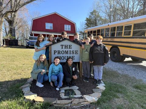 Students of the Hazel Grove Elementary Teach One to Lead One program stand with the Family Promise sign outside of the Family Promise of White and Habersham facility, a nonprofit dedicated to remedying homelessness in the North Georgia region. Pictured from left to right are (front) Violet Ramey, Brin Forrester, Aiyana Sutton, (back) Chloe Baird, Willow Ingebrigsten, Riley Gallahan, Konnor Tucker, Mason Harris, Matheo Garcia Vega and Ayden Meiburg. SUBMITTED