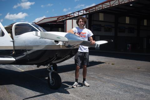 Habersham Central High School Senior Jackson Cribbs stands with one of the single engine planes he works with every day as a flight operations assistant at Horizon Dreams Aviation. After today’s graduation, Cribbs, who already holds an FAA private pilot license, will go on to study aviation at West Michigan University to be a professional aviation pilot. HANNAH CAUDELL/Staff