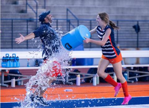 After trying to evade a water dousing from Abigail Hotard, Head Coach Jeff LaBarbera finally accepted his fate following his team’s statement win Tuesday. DIANA VEGA/HCHS