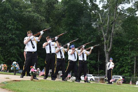 Honor Guard members Roy Albea Jr., Rob Wallace, Bob Trousdale, VFW Auxillary President Steven Hawkins and Dr. Ed Hendricks fire the volleys during the morning ceremony as Danny Stephens waits to play Taps. Samantha Sinclair/Staff