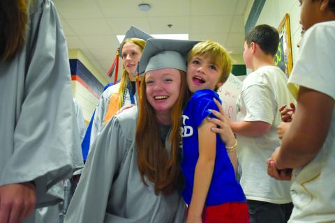 During the Elementary School Walk at Level Grove Elementary on Thursday,  Katelynn Lobuono gets a hug from third grader Lincoln Chitwood, one of the kids she knows from working at the Boys and Girls Club. SAMANTHA SINCLAIR/Staff