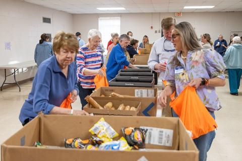 The folks from Food 4 Kids pack up some meals for kids in need in the Habersham County community. FILE