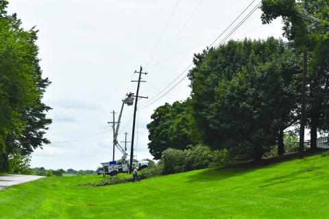 Habersham EMC crews work to repair power lines on Old Cleveland Road on Sunday afternoon. Samantha Sinclair/Staff